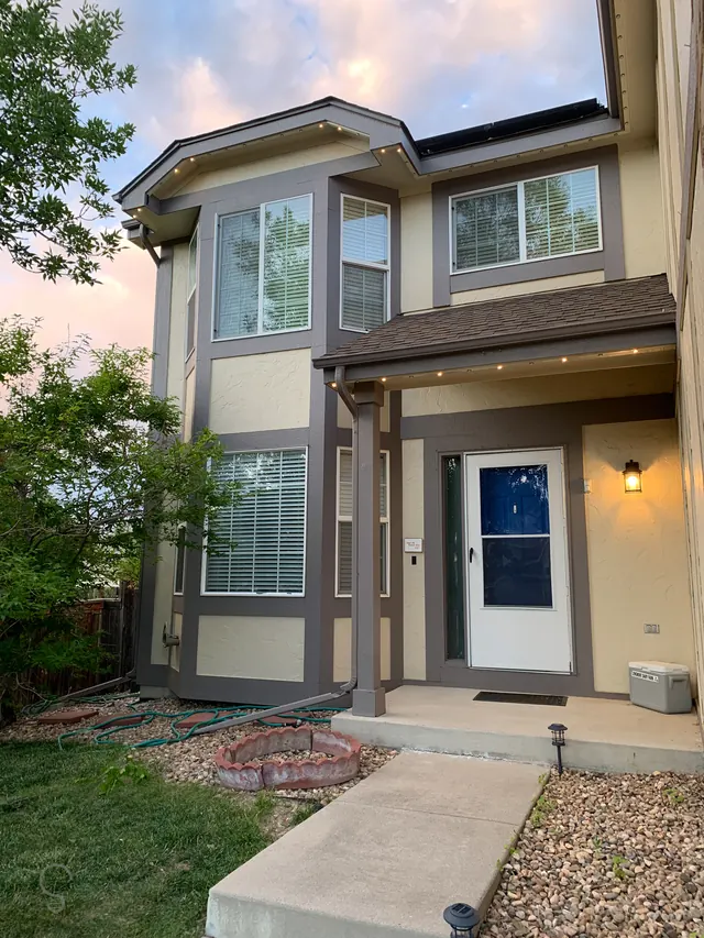 Warm white permanent roofline lighting on a Colorado home at night (photo 132 of 136)