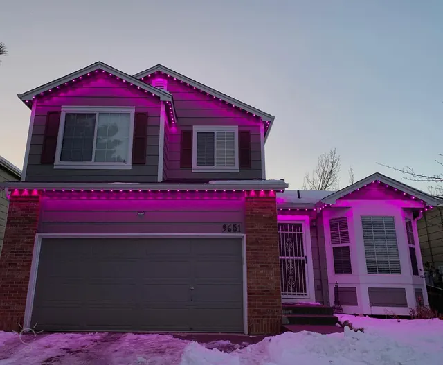 Warm white permanent roofline lighting on a Colorado home at night (photo 9 of 136)