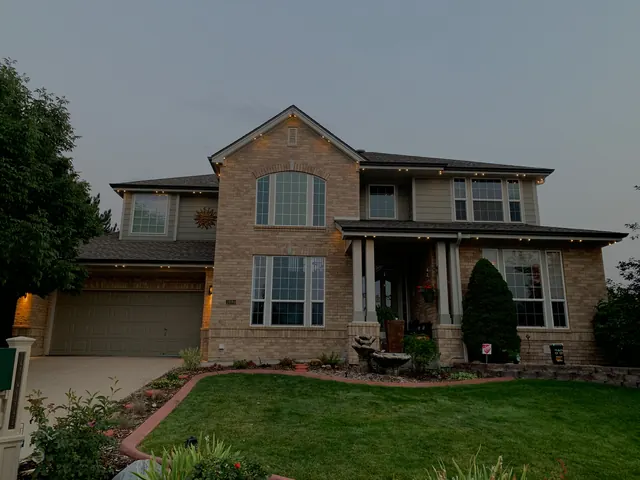 Warm white permanent roofline lighting on a Colorado home at night (photo 10 of 136)