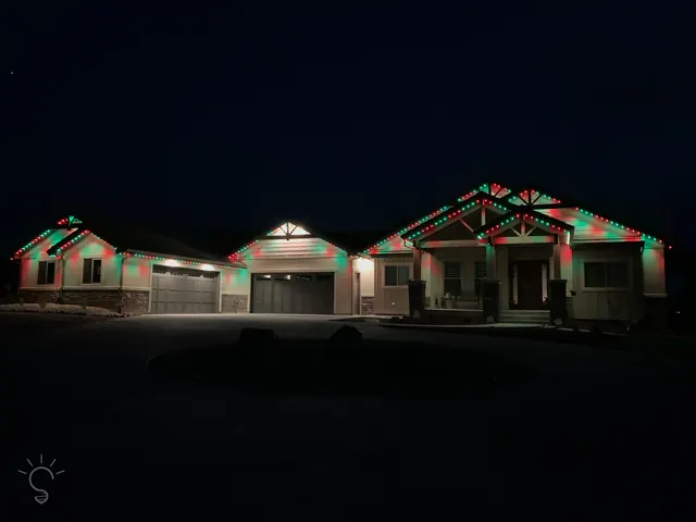 Warm white permanent roofline lighting on a Colorado home at night (photo 12 of 136)