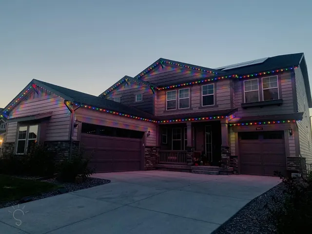 Warm white permanent roofline lighting on a Colorado home at night (photo 13 of 136)