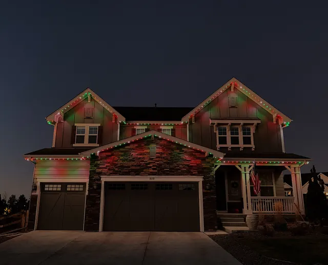 Warm white permanent roofline lighting on a Colorado home at night (photo 1 of 136)