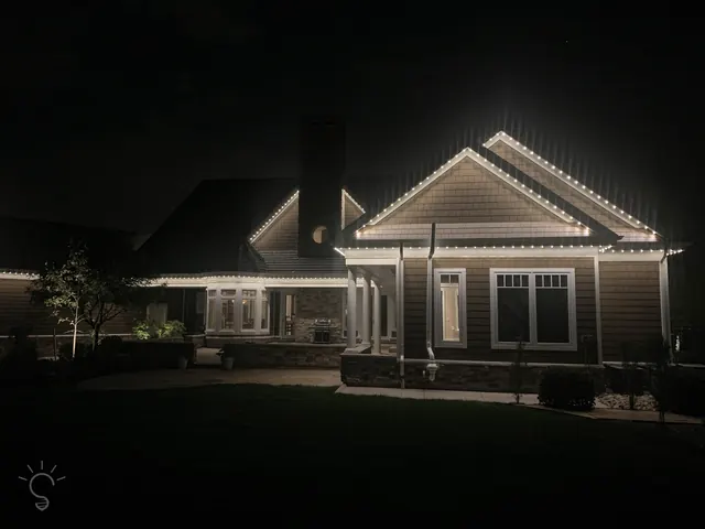 Warm white permanent roofline lighting on a Colorado home at night (photo 14 of 136)