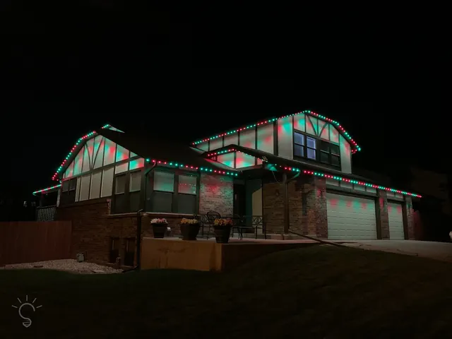 Warm white permanent roofline lighting on a Colorado home at night (photo 18 of 136)