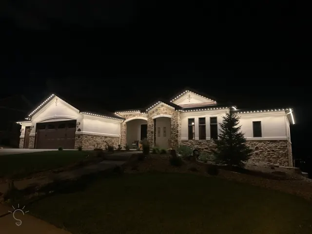 Warm white permanent roofline lighting on a Colorado home at night (photo 19 of 136)