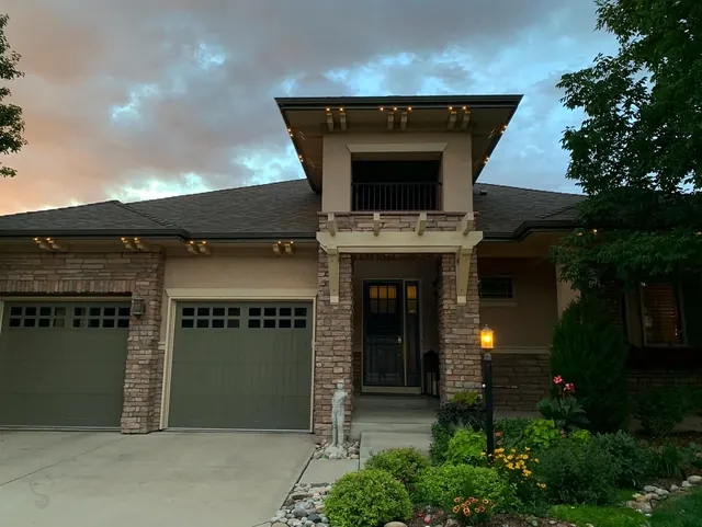 Warm white permanent roofline lighting on a Colorado home at night (photo 23 of 136)
