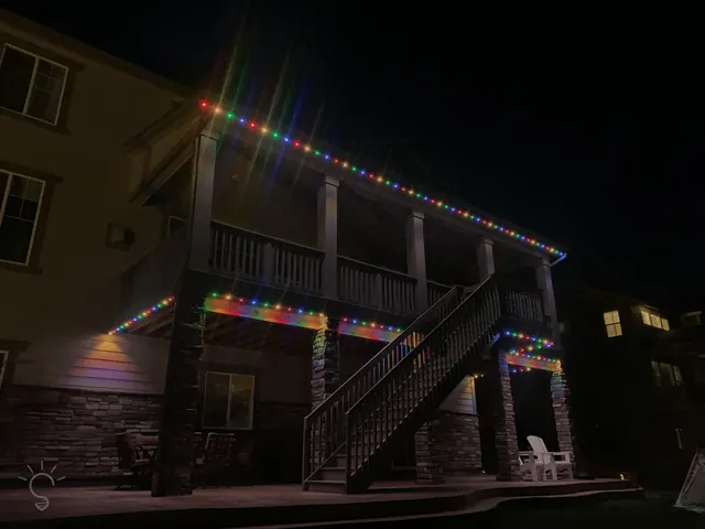 Warm white permanent roofline lighting on a Colorado home at night (photo 25 of 136)