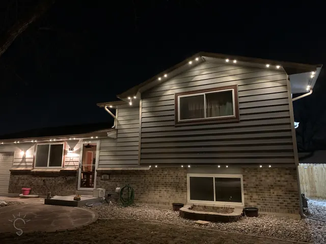 Warm white permanent roofline lighting on a Colorado home at night (photo 26 of 136)