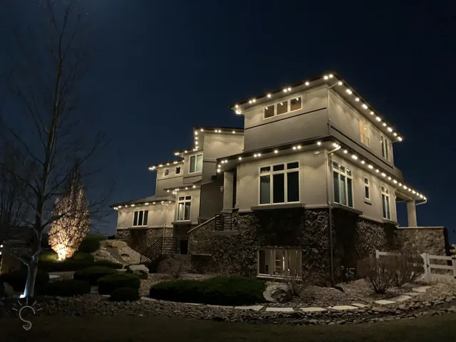 Warm white permanent roofline lighting on a Colorado home at night (photo 3 of 136)
