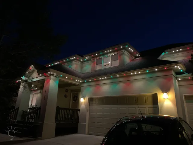 Warm white permanent roofline lighting on a Colorado home at night (photo 30 of 136)