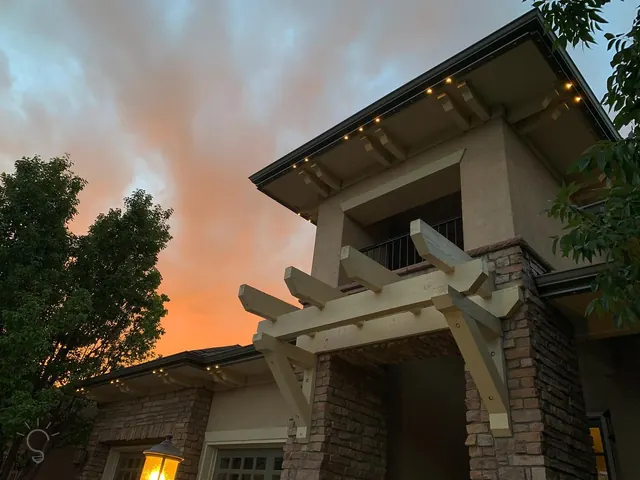 Warm white permanent roofline lighting on a Colorado home at night (photo 31 of 136)