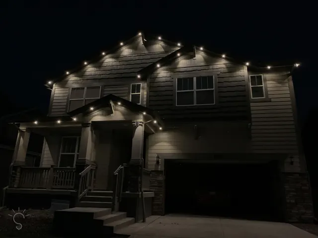Warm white permanent roofline lighting on a Colorado home at night (photo 33 of 136)