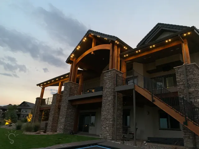 Warm white permanent roofline lighting on a Colorado home at night (photo 34 of 136)