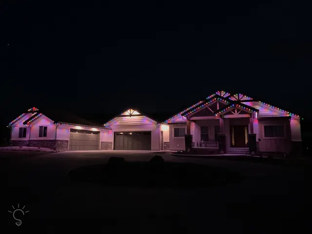 Warm white permanent roofline lighting on a Colorado home at night (photo 35 of 136)