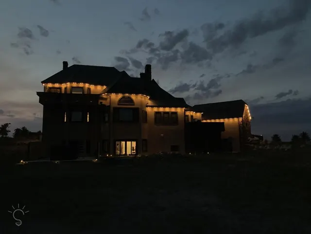 Warm white permanent roofline lighting on a Colorado home at night (photo 8 of 136)