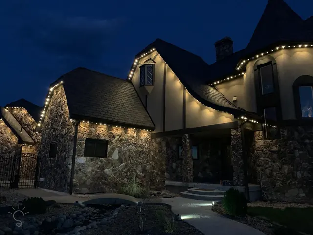 Warm white permanent roofline lighting on a Colorado home at night (photo 39 of 136)