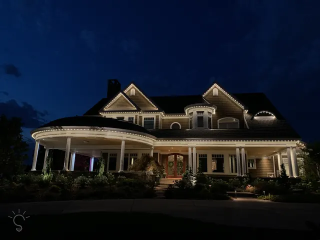 Warm white permanent roofline lighting on a Colorado home at night (photo 41 of 136)