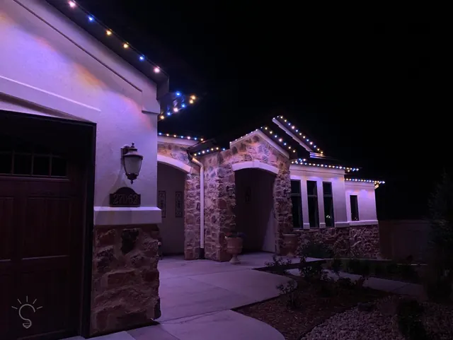 Warm white permanent roofline lighting on a Colorado home at night (photo 42 of 136)