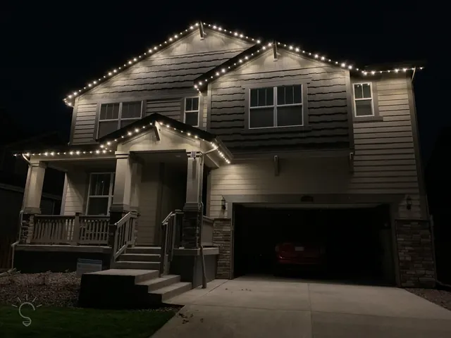 Warm white permanent roofline lighting on a Colorado home at night (photo 2 of 136)