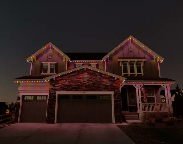 Warm white permanent roofline lighting on a Colorado home at night (photo 43 of 136)
