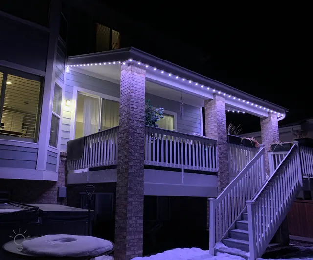 Warm white permanent roofline lighting on a Colorado home at night (photo 45 of 136)