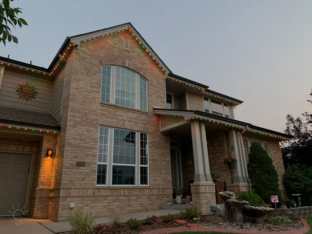 Warm white permanent roofline lighting on a Colorado home at night (photo 47 of 136)