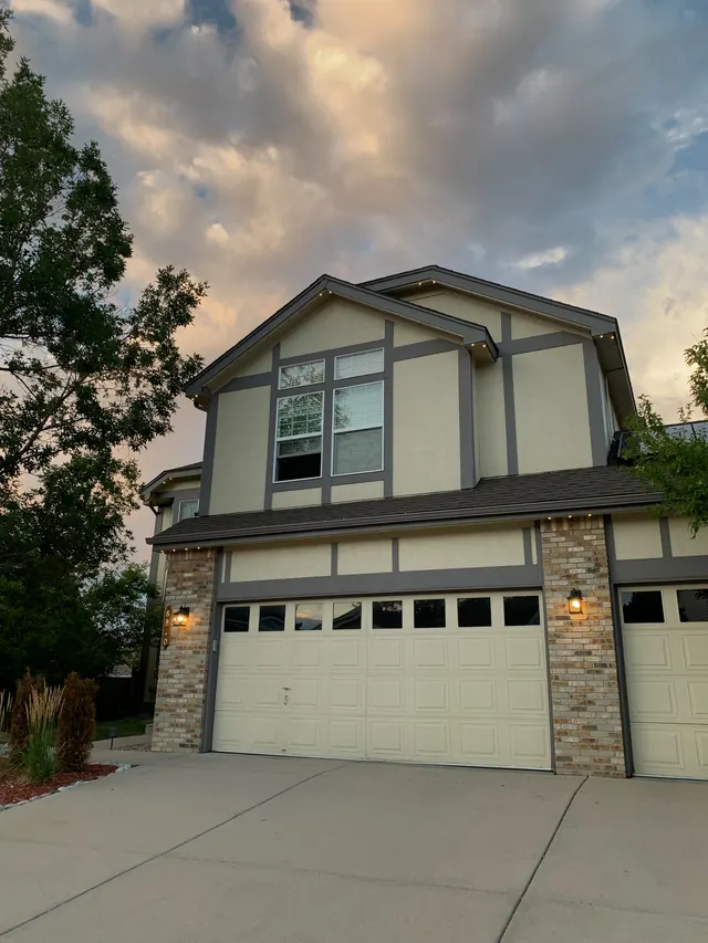 Warm white permanent roofline lighting on a Colorado home at night (photo 133 of 136)