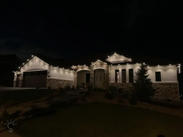 Warm white permanent roofline lighting on a Colorado home at night (photo 48 of 136)