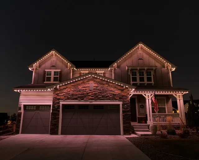 Warm white permanent roofline lighting on a Colorado home at night (photo 51 of 136)