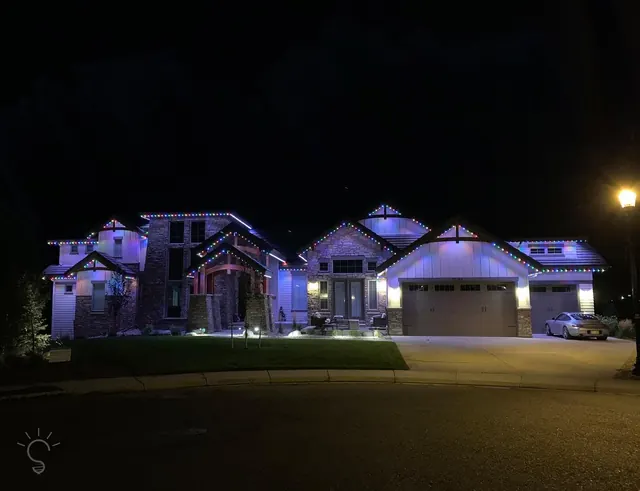 Warm white permanent roofline lighting on a Colorado home at night (photo 52 of 136)