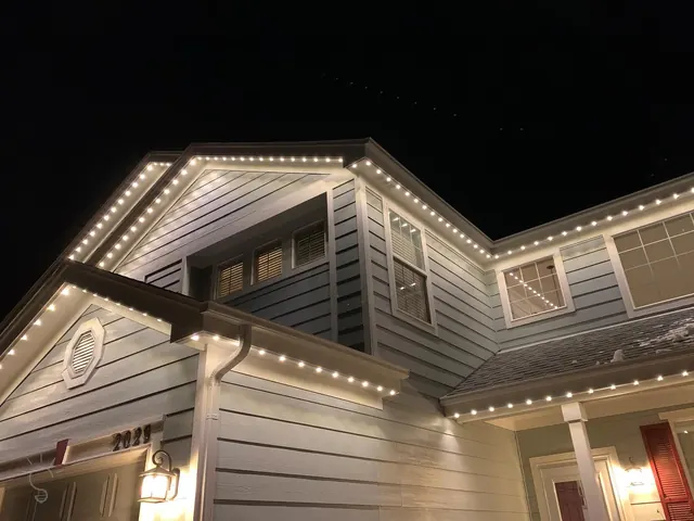 Warm white permanent roofline lighting on a Colorado home at night (photo 5 of 136)