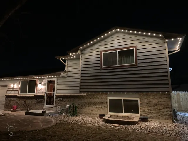 Warm white permanent roofline lighting on a Colorado home at night (photo 53 of 136)