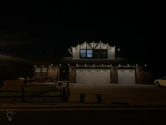 Warm white permanent roofline lighting on a Colorado home at night (photo 54 of 136)