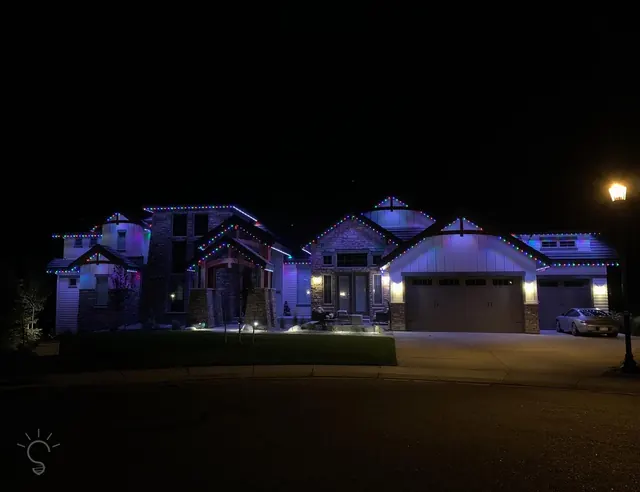 Warm white permanent roofline lighting on a Colorado home at night (photo 55 of 136)
