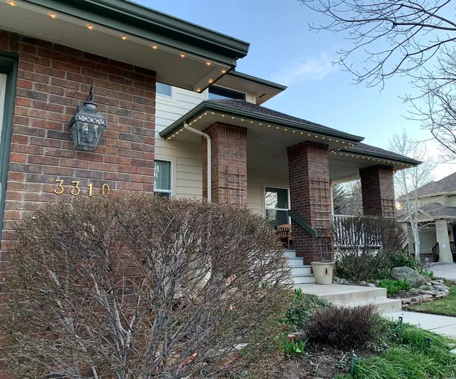 Warm white permanent roofline lighting on a Colorado home at night (photo 57 of 136)