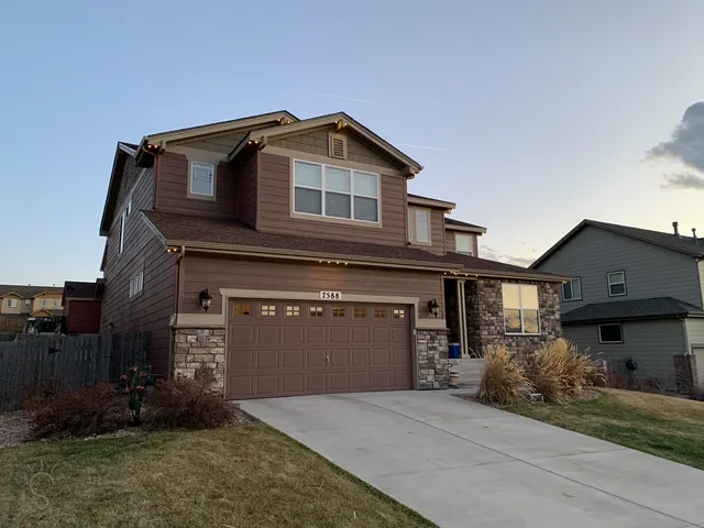 Warm white permanent roofline lighting on a Colorado home at night (photo 59 of 136)