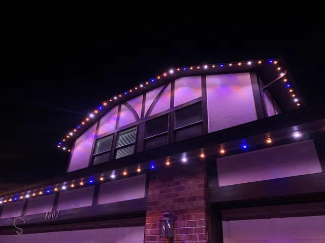 Gemstone permanent roofline lights in holiday colors on a Colorado home (photo 60 of 136)