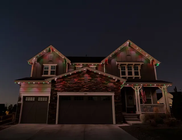 Warm white permanent roofline lighting on a Colorado home at night (photo 6 of 136)