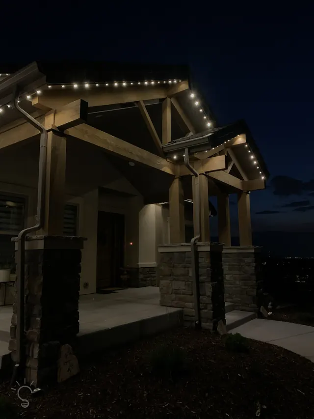 Warm white permanent roofline lighting on a Colorado home at night (photo 61 of 136)