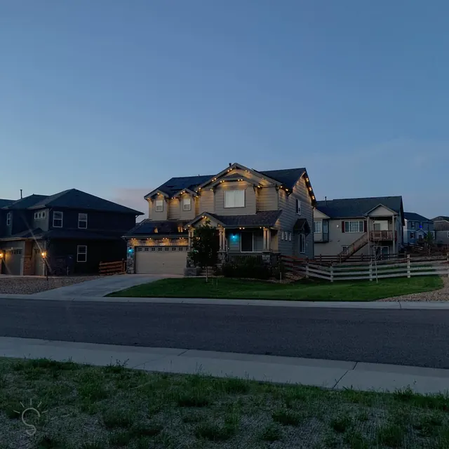 Warm white permanent roofline lighting on a Colorado home at night (photo 135 of 136)
