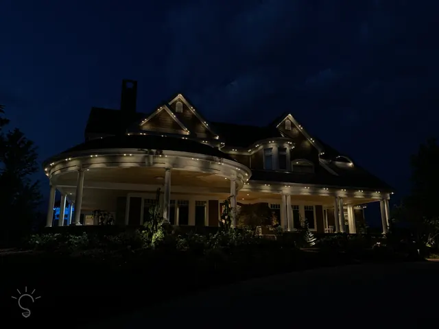 Warm white permanent roofline lighting on a Colorado home at night (photo 62 of 136)
