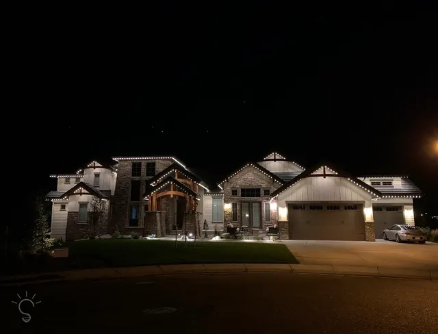 Warm white permanent roofline lighting on a Colorado home at night (photo 63 of 136)
