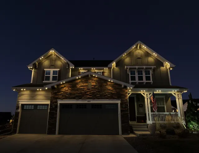 Warm white permanent roofline lighting on a Colorado home at night (photo 67 of 136)