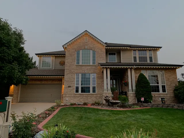 Warm white permanent roofline lighting on a Colorado home at night (photo 68 of 136)
