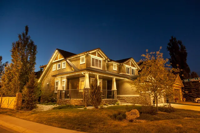 Warm white permanent roofline lighting on a Colorado home at night (photo 72 of 136)