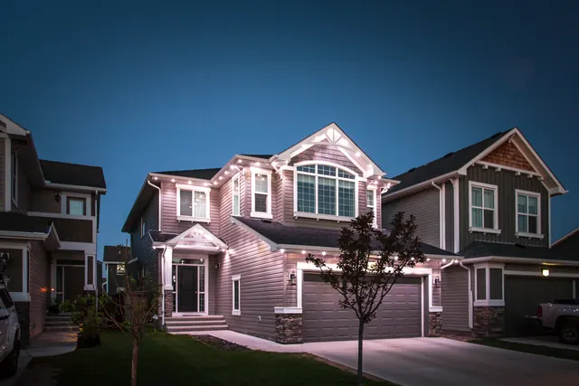 Warm white permanent roofline lighting on a Colorado home at night (photo 75 of 136)