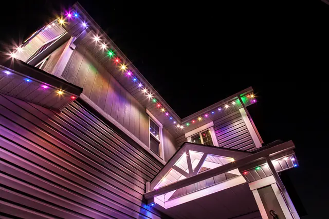 Warm white permanent roofline lighting on a Colorado home at night (photo 77 of 136)