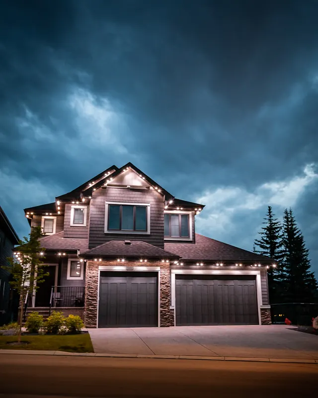 Warm white permanent roofline lighting on a Colorado home at night (photo 80 of 136)