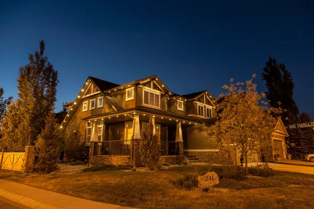 Warm white permanent roofline lighting on a Colorado home at night (photo 81 of 136)