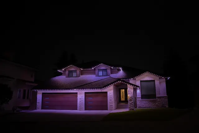 Warm white permanent roofline lighting on a Colorado home at night (photo 85 of 136)